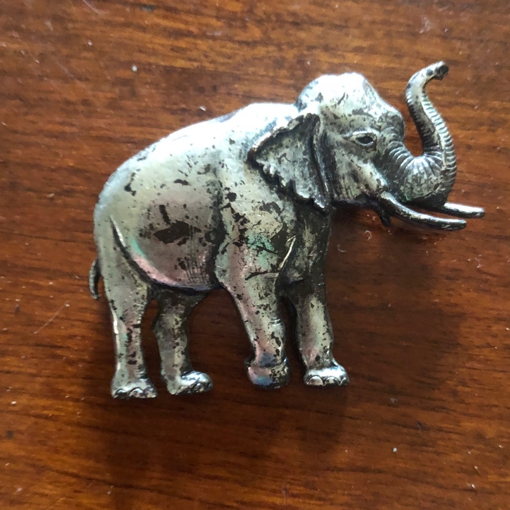 vintage silver-tone metal elephant brooch featuring  a raised trunk